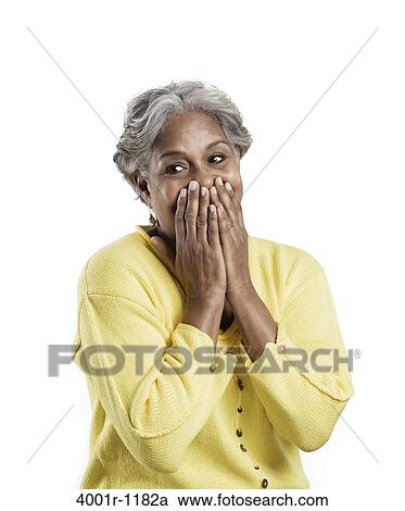 Senior woman covering her mouth with hands View Large Photo Image Stock Image - Senior woman covering her mouth with hands. Fotosearch