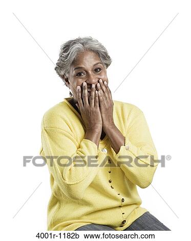 Senior woman covering her mouth with hands View Large Photo Image Stock Image - Senior woman covering her mouth with hands. Fotosearch
