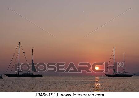 Silhouette of boats at sunset, Mykonos Town, Mykonos, Cyclades Islands, Greece View Large Photo Image Stock Image - Silhouette of boats at sunset, Mykonos Town, Mykonos, Cyclades Islands, Greece. Fotosearch