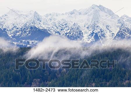 Stock Image - Snowcapped mountain range, Alderbrook Inn, Olympic Mountains, Hood Canal, Seabeck, Kitsap County, Washington State, USA. Fotosearch