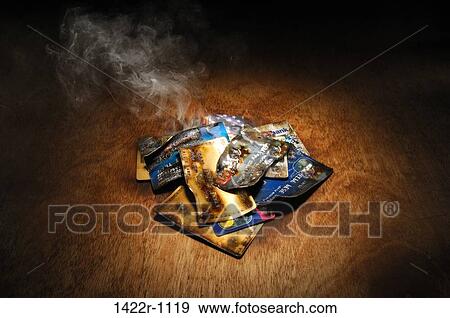 Stock Photo - Stack of burnt credit cards. Fotosearch