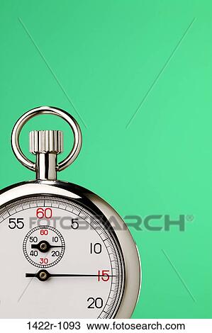 Stock Image - Stopwatch against green background. Fotosearch