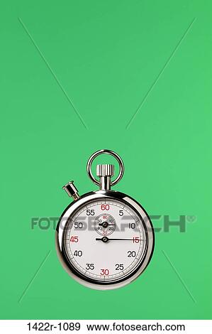 Stock Photo - Stopwatch against green background. Fotosearch