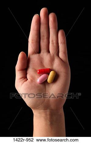 Three colorful capsules in the palm of a person View Large Photo Image Stock Image - Three colorful capsules in the palm of a person. Fotosearch