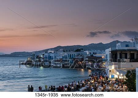 Tourists at a restaurant, Little Venice, Mykonos Town, Mykonos, Cyclades Islands, Greece View Large Photo Image Stock Photography - Tourists at a restaurant, Little Venice, Mykonos Town, Mykonos, Cyclades Islands, Greece. Fotosearch