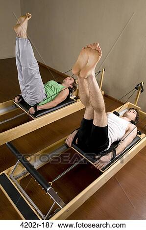 Two young men exercising in a gym View Large Photo Image Stock Photo - Two young men exercising in a gym. Fotosearch