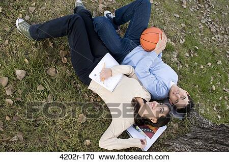 Stock Image - University students relaxing on campus. Fotosearch