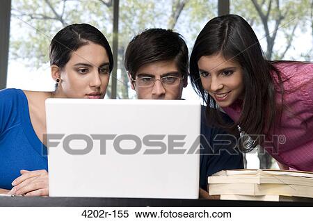 University students working on a laptop in a classroom View Large Photo Image Stock Photography - University students working on a laptop in a classroom. Fotosearch