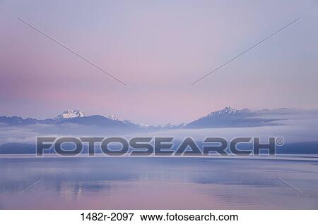 Stock Photo - USA, Washington, Seabeck, Hood Canal, The Brothers, Olympic Mountains, view on sunrise. Fotosearch