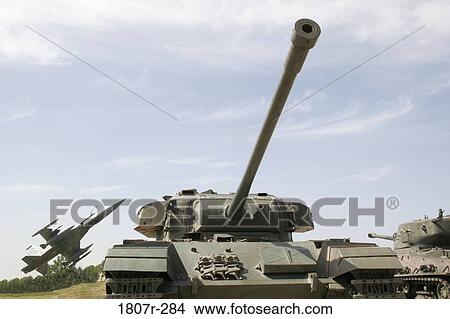War tank with a fighter jet in the background View Large Photo Image Picture - War tank with a fighter jet in the background. Fotosearch
