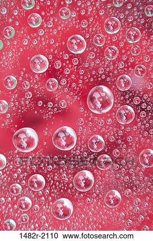 Stock Image - Water drops on glass - red rose in background. Fotosearch