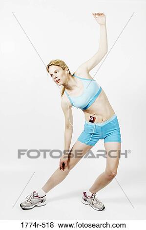 Woman exercising and listening to music with an MP3 player View Large Photo Image Stock Photo - Woman exercising and listening to music with an MP3 player. Fotosearch