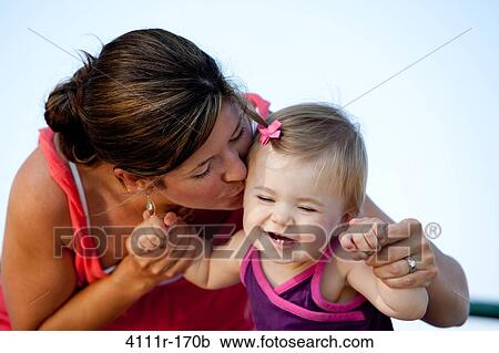 Woman kissing her daughter View Large Photo Image Stock Image - Woman kissing her daughter. Fotosearch