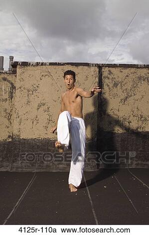 Young man practicing martial arts, New York City, New York State, USA View Large Photo Image Stock Image - Young man practicing martial arts, New York City, New York State, USA. Fotosearch