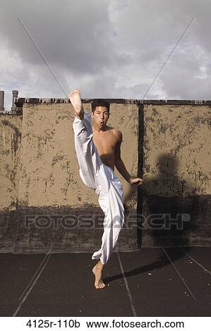Young man practicing martial arts, New York City, New York State, USA View Large Photo Image Stock Image - Young man practicing martial arts, New York City, New York State, USA. Fotosearch