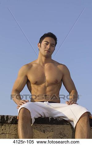 Young man sitting on the rooftop, New York City, New York State, USA View Large Photo Image Stock Photography - Young man sitting on the rooftop, New York City, New York State, USA. Fotosearch