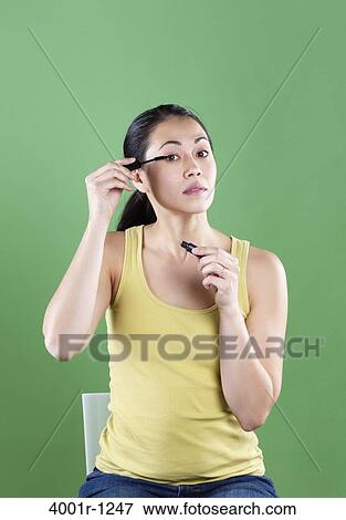 Young woman applying mascara View Large Photo Image Stock Photo - Young woman applying mascara. Fotosearch