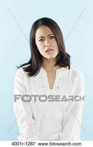 Young woman biting her lips View Large Photo Image Stock Photo - Young woman biting her lips. Fotosearch