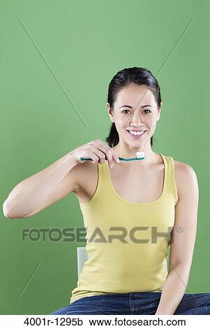 Young woman brushing teeth View Large Photo Image Stock Image - Young woman brushing teeth. Fotosearch