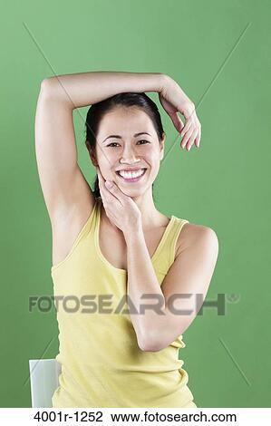 Stock Image - Young woman posing and smiling. Fotosearch