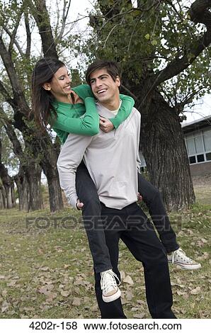 Young woman riding piggyback on his boyfriend View Large Photo Image Stock Photo - Young woman riding piggyback on his boyfriend. Fotosearch