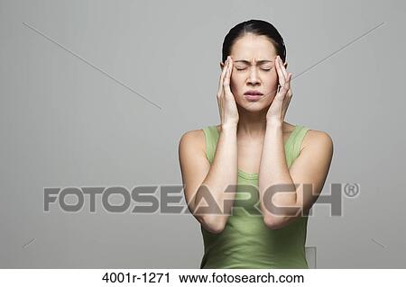 Young woman suffering from a headache View Large Photo Image Stock Image - Young woman suffering from a headache. Fotosearch