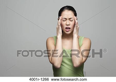 Young woman suffering from a headache View Large Photo Image Stock Photograph - Young woman suffering from a headache. Fotosearch