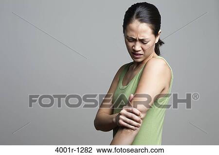 Young woman suffering from elbow pain View Large Photo Image Stock Image - Young woman suffering from elbow pain. Fotosearch