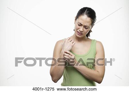 Young woman suffering with pain in her wrist View Large Photo Image Stock Photography - Young woman suffering with pain in her wrist. Fotosearch