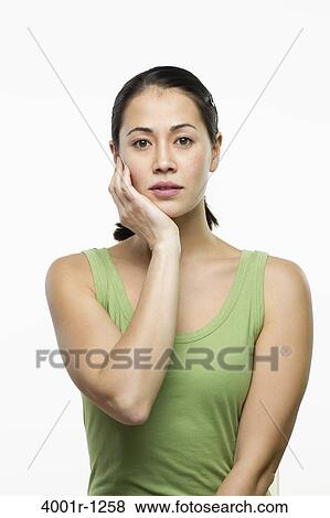 Stock Photo - Young woman thinking and looking sad. Fotosearch