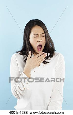Stock Photo - Young woman yawning. Fotosearch