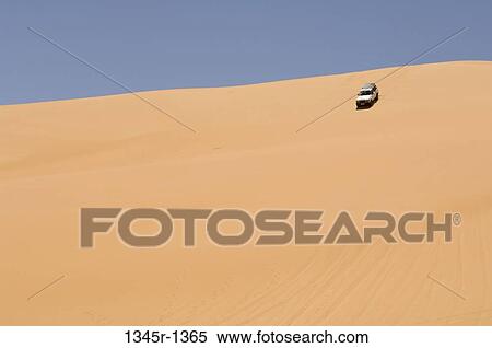 Stock Photography - 4x4 vehicle in a desert, Erg Awbari, Fezzan, Libya. Fotosearch