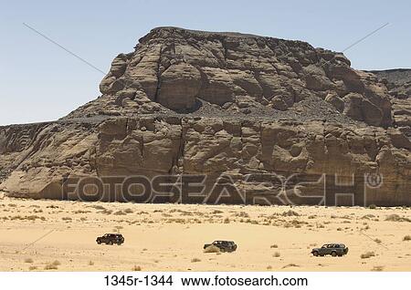 4x4 vehicles near rock formations, Wadi Teshuinat, Tadrart Acacus, Fezzan, Libya View Large Photo Image Picture - 4x4 vehicles near rock formations, Wadi Teshuinat, Tadrart Acacus, Fezzan, Libya. Fotosearch
