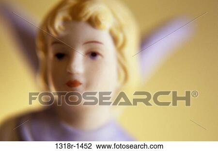 Atmospheric face head and wings of painted porcelain young angel with golden hair in warm light Norfolk UK View Large Photo Image Stock Image - Atmospheric face head and wings of painted porcelain young angel with golden hair in warm light Norfolk UK. Fotosearch