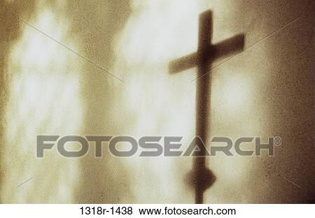 Atmospheric shadows in warm light on cream wall of leaded church window and large crucifix on pole Norfolk UK View Large Photo Image Stock Photo - Atmospheric shadows in warm light on cream wall of leaded church window and large crucifix on pole Norfolk UK. Fotosearch