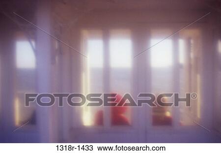 Atmospheric view from behind of couple in winter clothes sitting in seaside shelter looking out at gray sunlit sea Cromer Norfolk UK View Large Photo Image Stock Image - Atmospheric view from behind of couple in winter clothes sitting in seaside shelter looking out at gray sunlit sea Cromer Norfolk UK. Fotosearch