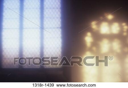 Atmospheric view of diamond leaded church window next to projection onto wall of light from Decorated Gothic window Norfolk UK View Large Photo Image Stock Photo - Atmospheric view of diamond leaded church window next to projection onto wall of light from Decorated Gothic window Norfolk UK. Fotosearch