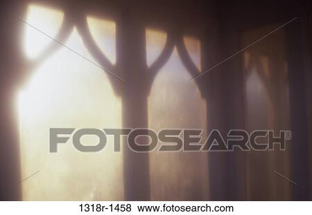 Atmospheric view of low winter sunlight thru glass of ornate conservatory or shelter Norfolk UK View Large Photo Image Stock Photo - Atmospheric view of low winter sunlight thru glass of ornate conservatory or shelter Norfolk UK. Fotosearch
