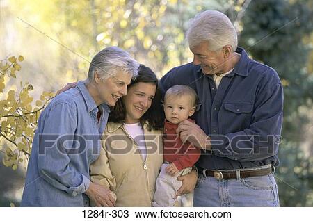 Stock Image - Baby boy with his mother and grandparents. Fotosearch