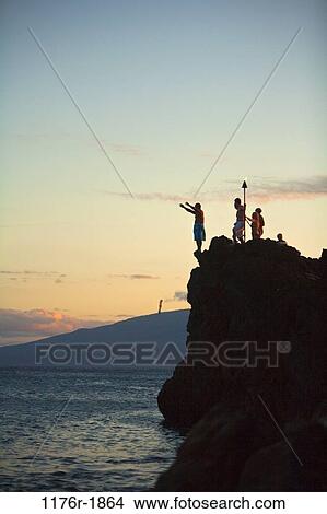 Picture - Black Rock sunset torch lighting and cliff diving ceremony, Maui, Hawaii. Fotosearch