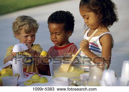 Boy and two girls making lemonade View Large Photo Image Stock Image - Boy and two girls making lemonade. Fotosearch