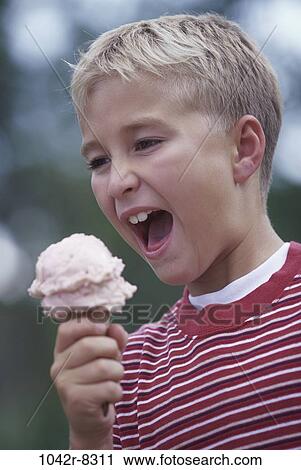 Boy eating an ice cream cone View Large Photo Image Stock Image - Boy eating an ice cream cone. Fotosearch
