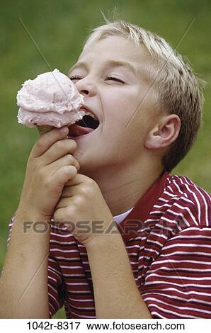 Boy eating an ice cream cone View Large Photo Image Stock Photo - Boy eating an ice cream cone. Fotosearch