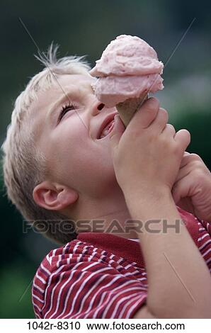 Boy holding up an ice cream cone View Large Photo Image Stock Image - Boy holding up an ice cream cone. Fotosearch