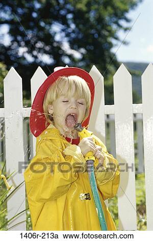 Boy playing with a garden hose View Large Photo Image Stock Image - Boy playing with a garden hose. Fotosearch