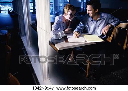 Businessman and a businesswoman sitting in a restaurant View Large Photo Image Stock Photo - Businessman and a businesswoman sitting in a restaurant. Fotosearch