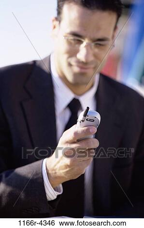 Stock Photograph - Businessman holding a mobile phone. Fotosearch