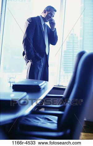 Stock Image - Businessman talking on a mobile phone. Fotosearch