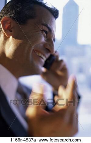 Businessman talking on a mobile phone View Large Photo Image Stock Image - Businessman talking on a mobile phone. Fotosearch