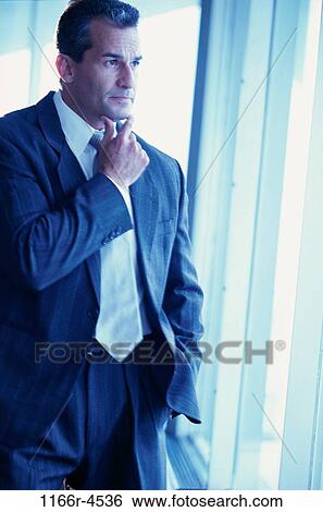 Stock Photograph - Businessman thinking with his hand on his chin. Fotosearch